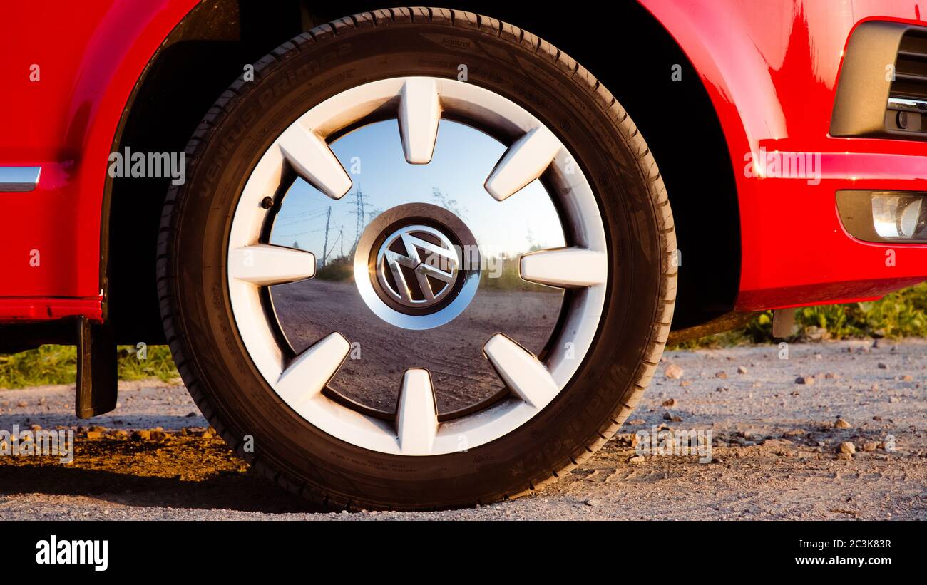 St. Petersburg, Russia - July 22, 2019: Red and white colored modern  Volkswagen Multivan California Ocean (Transporter T6). Is parked on the  country road. Wheels closeup Stock Photo - Alamy
