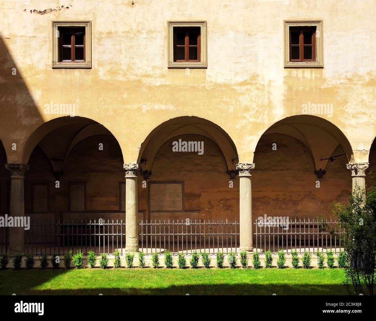 Flat Symmetrical View of Traditional Italian Facade & Arcade under Noon Sunlight in Florence, Italy Stock Photo