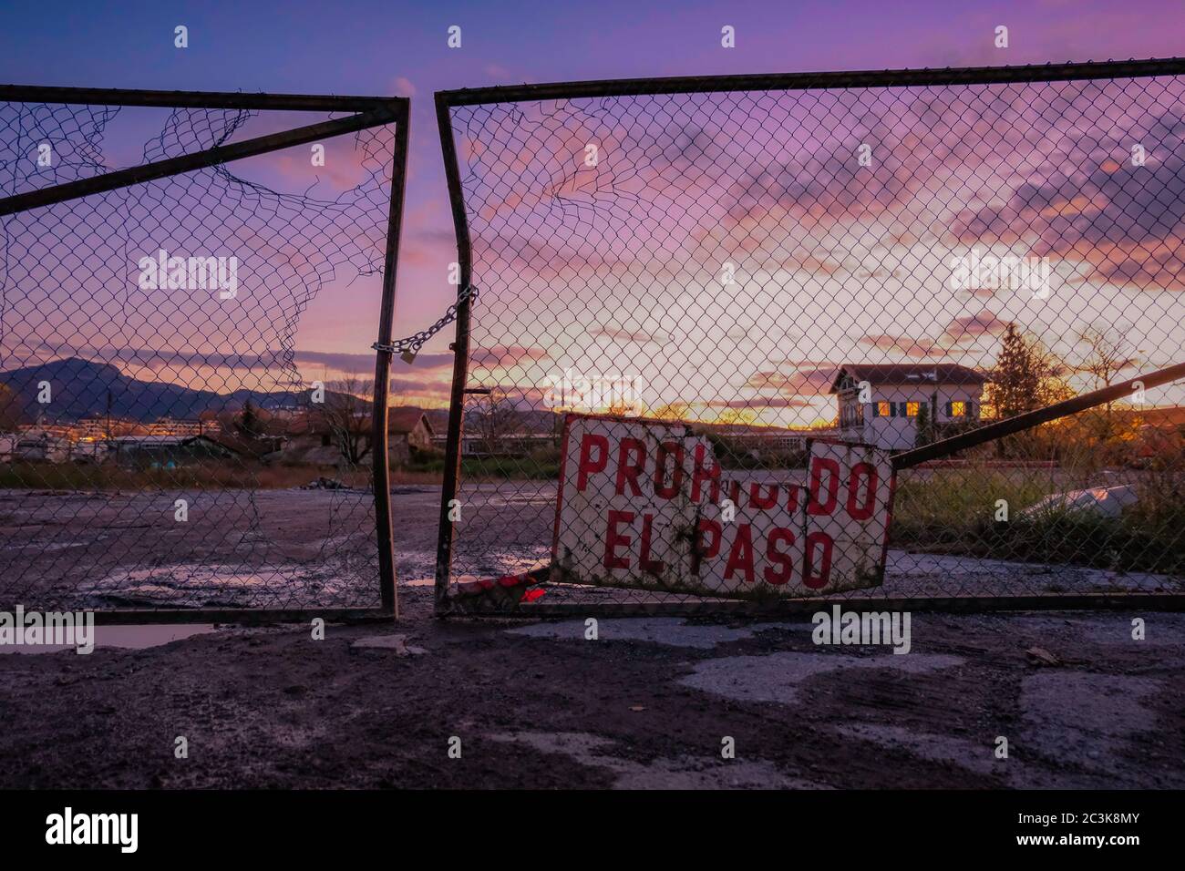 Prohibido el Paso sign on an old fence during sunset Stock Photo