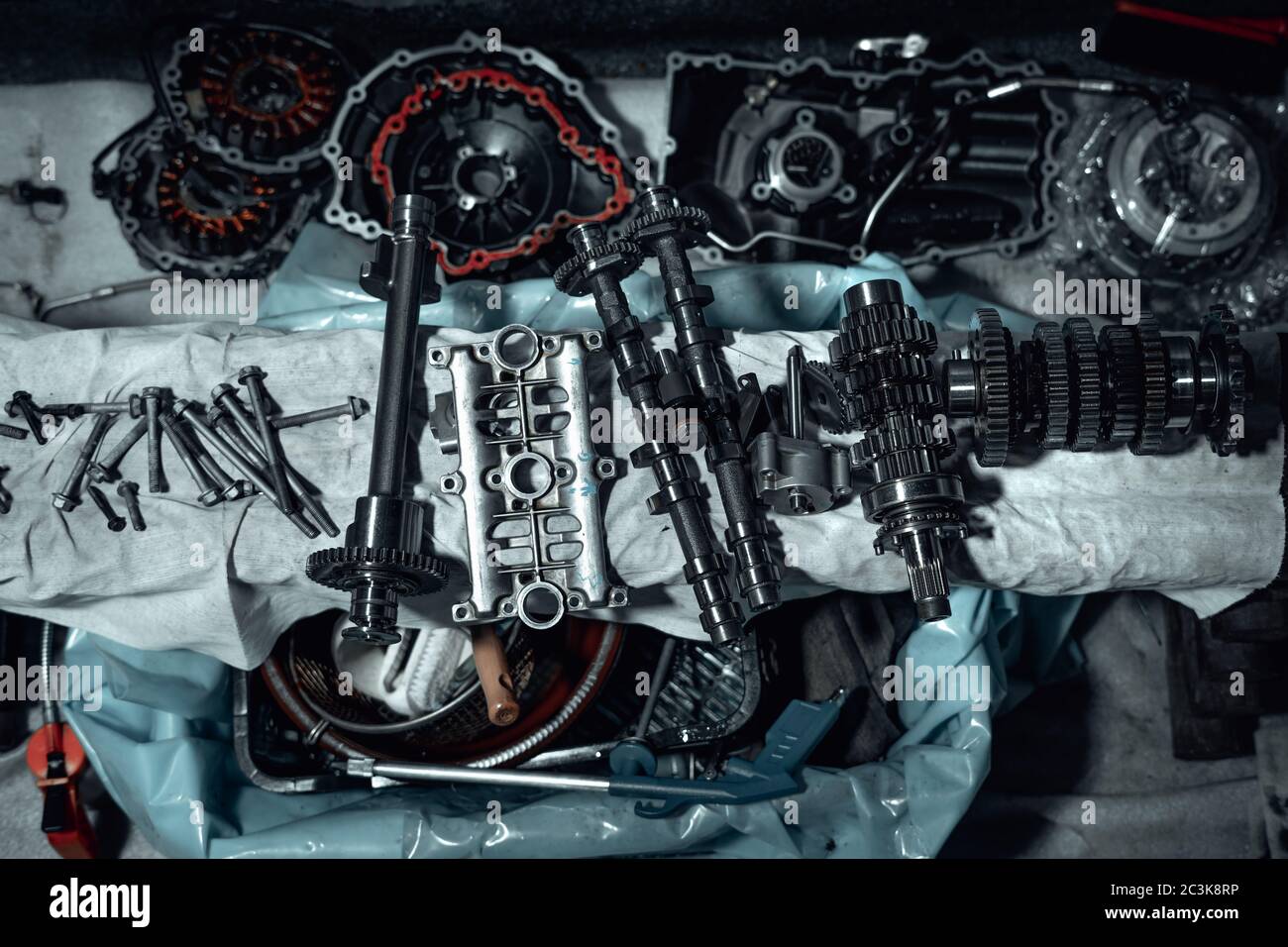 Disassembled fast motorcycle engine with visible transmission, locking valve, gear and piston parts. Sixteen valves and four cylinder motor. Stock Photo