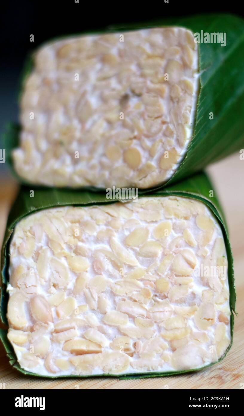 Raw tempeh on wooden board. Tempeh is a traditional soy product