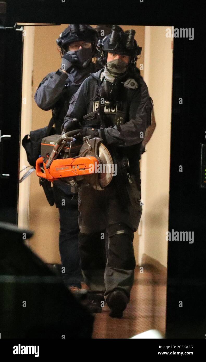 Armed police officers at a block of flats off the Basingstoke Rd in Reading after an incident at Forbury Gardens in Reading town centre. Stock Photo