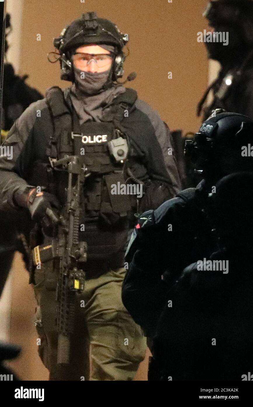 Armed police officers at a block of flats off the Basingstoke Rd in Reading after an incident at Forbury Gardens in Reading town centre. Stock Photo