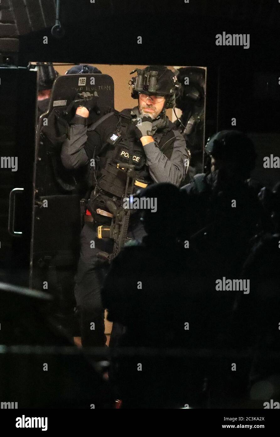 Armed police officers at a block of flats off the Basingstoke Rd in Reading after an incident at Forbury Gardens in Reading town centre. Stock Photo