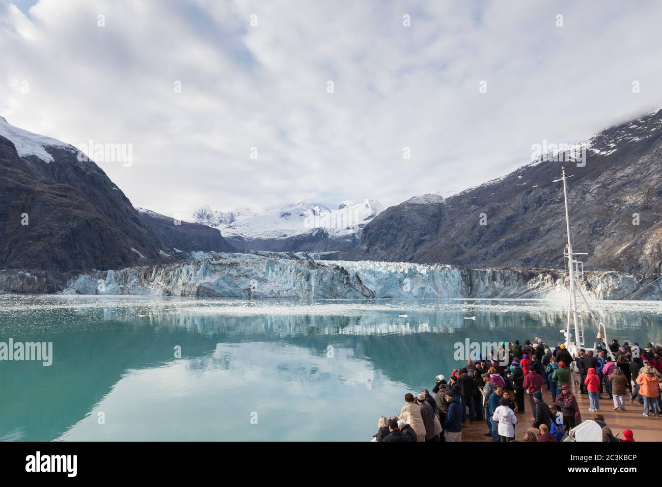 Visitors gathered on the bow of the MS Westerdam cruise ship to view Johns Hopkins Glacier from Johns Hopkins Inlet in Glacier Bay National Park and P Stock Photo