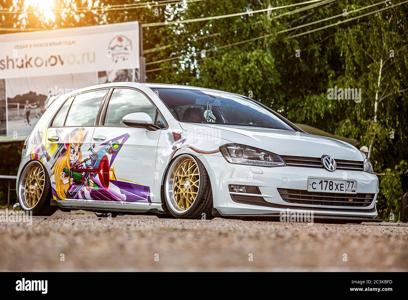 Moscow, Russia: July 06, 2019: Tuned by low suspension and custom wide  golden colored wheels. White volkswagen golf 7 with aerography on which  painted Chip and Dale characters Stock Photo - Alamy