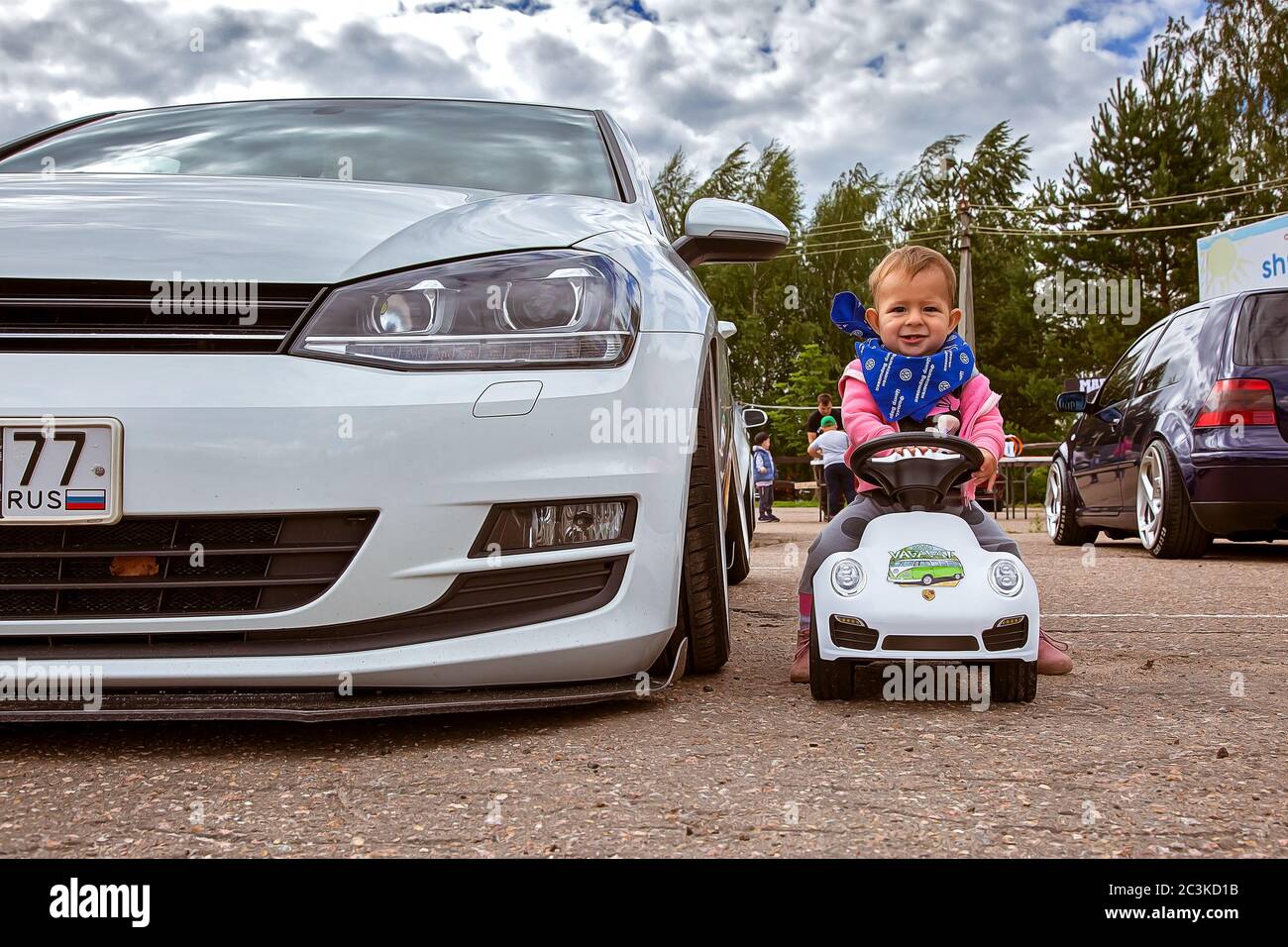 Moscow, Russia: July 06, 2019: Real car Volkswagen golf 7 near baby who  sits on a toy vehicle near tuned by low suspension and custom wheels. Ready  to race Stock Photo - Alamy