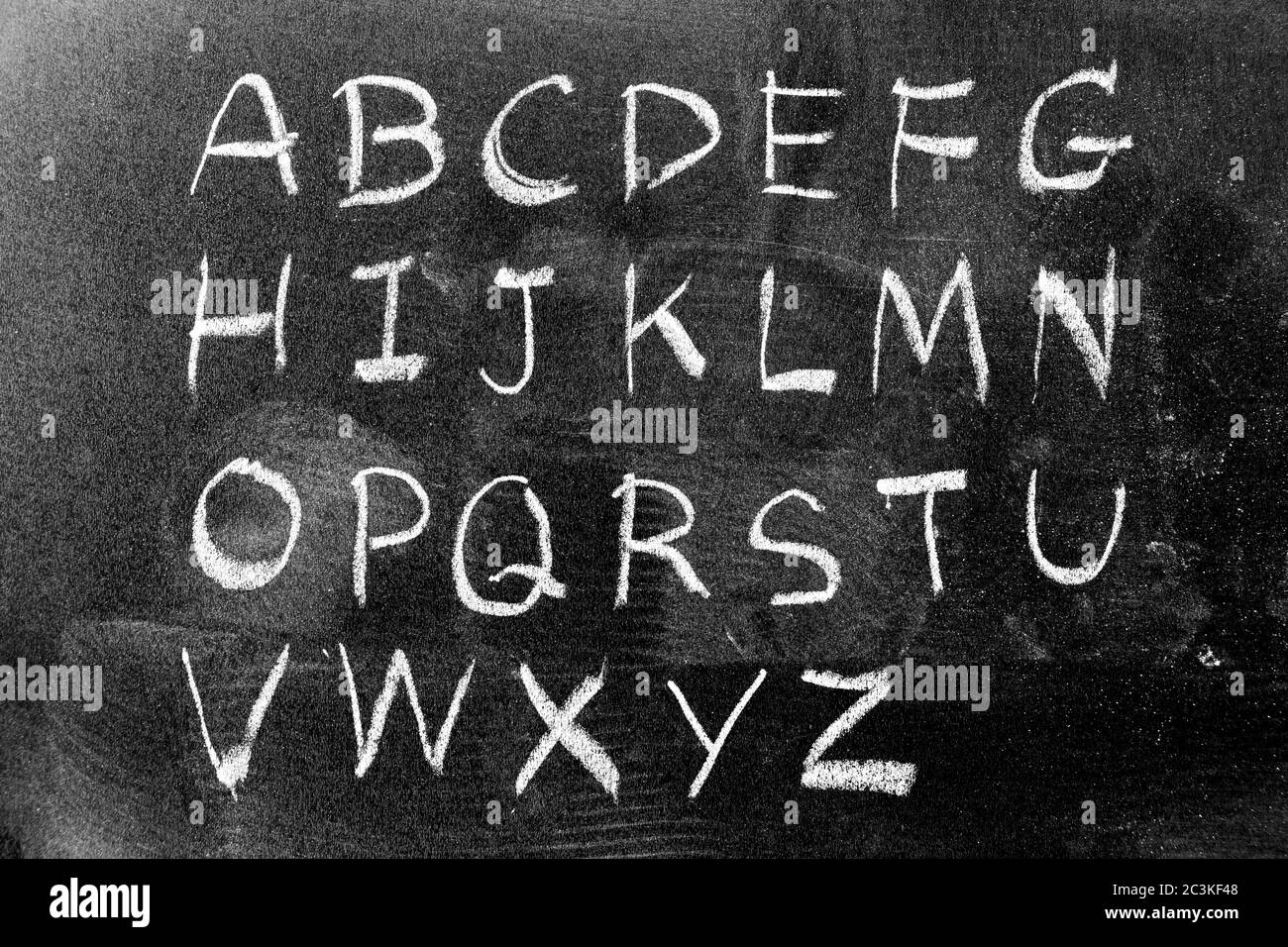 White color chalk hand writing in english capital letter on black board background Stock Photo