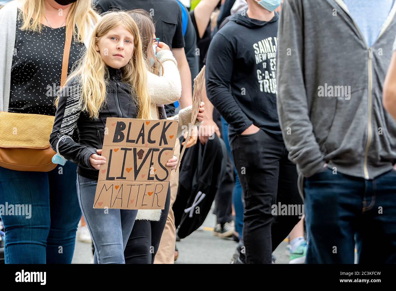 Saint John, NB, Canada - June 14, 2020: A young caucasian teen carries a Black Lives Matter sign as she marches in a rally. Stock Photo