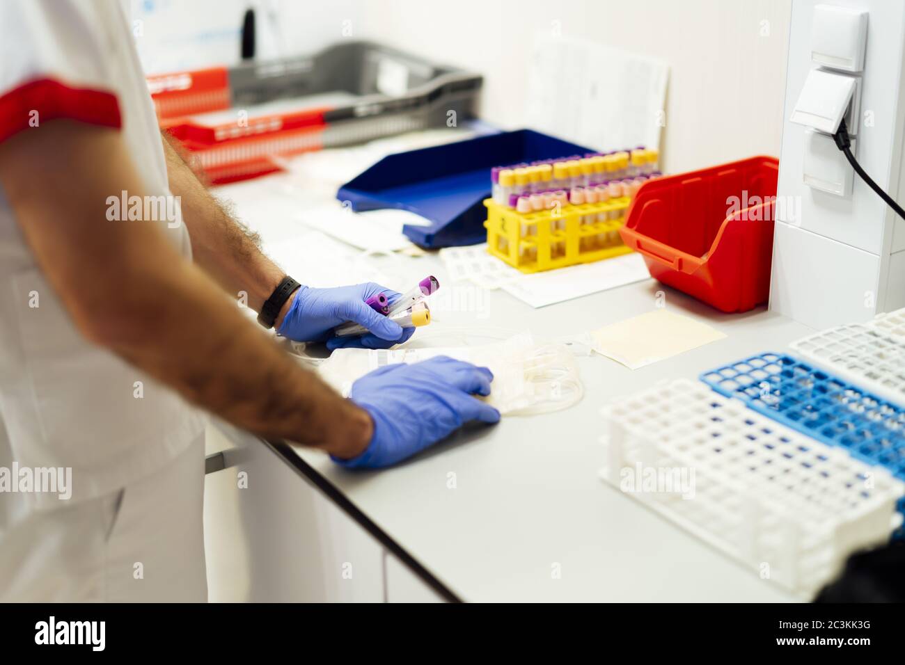 Laboratory assistant analyzing a blood sample Stock Photo - Alamy