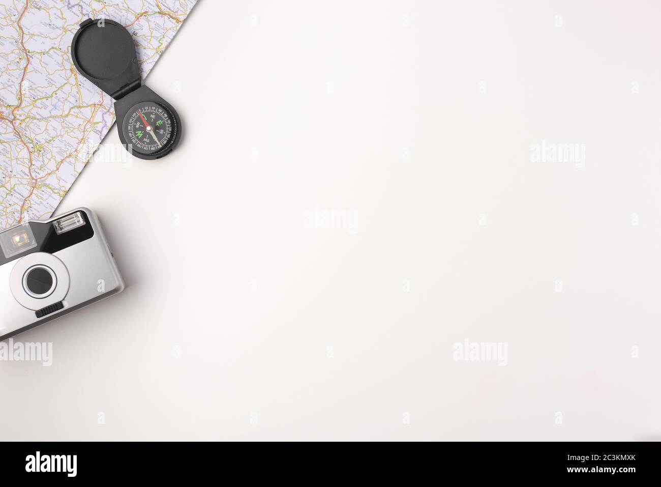 Traveler accessories. Map with vintage photo camera and compas on white ...