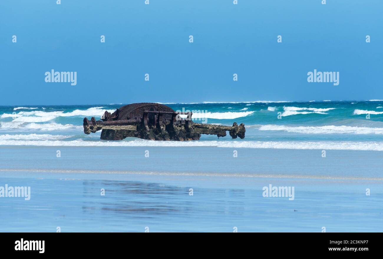 The rusting remains of the boiler and drive shaft of the paddle steamer Shannon. At Yellow rock beach, King Island, Austrlia. Stock Photo