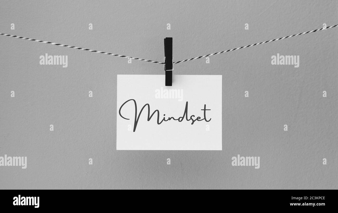Paper hanging on a rope with a brooch with a phrase. Inspirational quote written with the phrase mindset. Concept of mind, mindfulness.  Card, banner, Stock Photo
