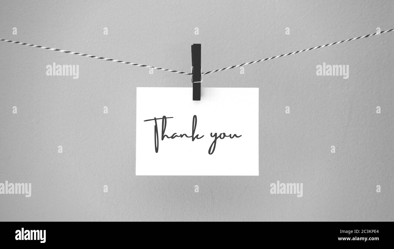 Paper hanging on a rope with a brooch with the phrase thank you. Inspirational quote.  Thank you card, banner, poster or design. Copy space. Stock Photo