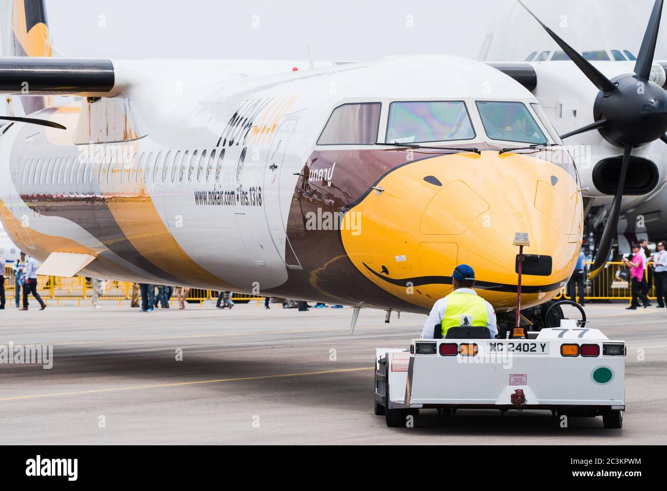 Singapore - February 17, 2016: Front of a Bombardier Q400 NextGen in Nok Air livery being pushed into position during Singapore Airshow at Changi Exhi Stock Photo