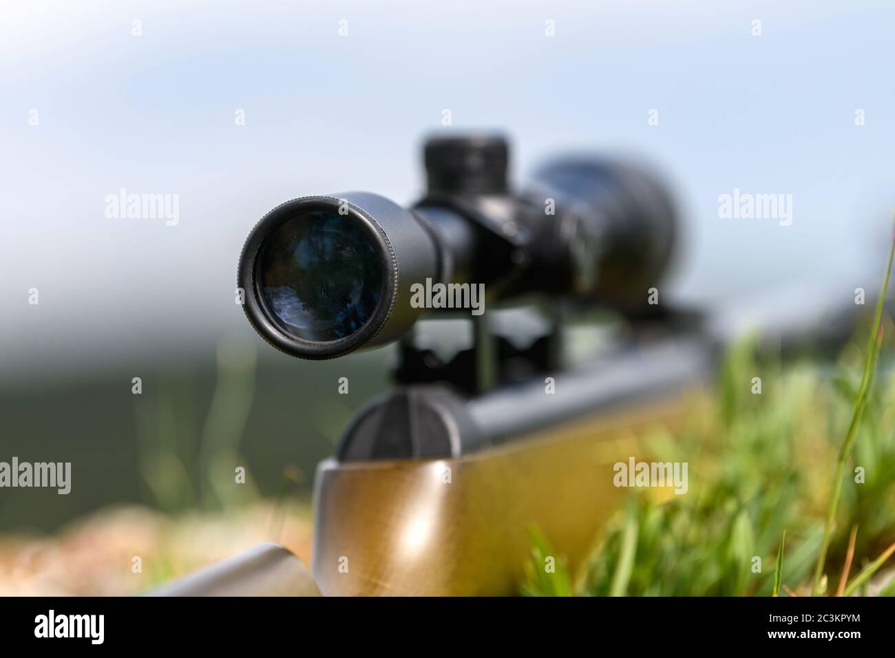 Close up rifle scope on the street with blurry background. Hunting 