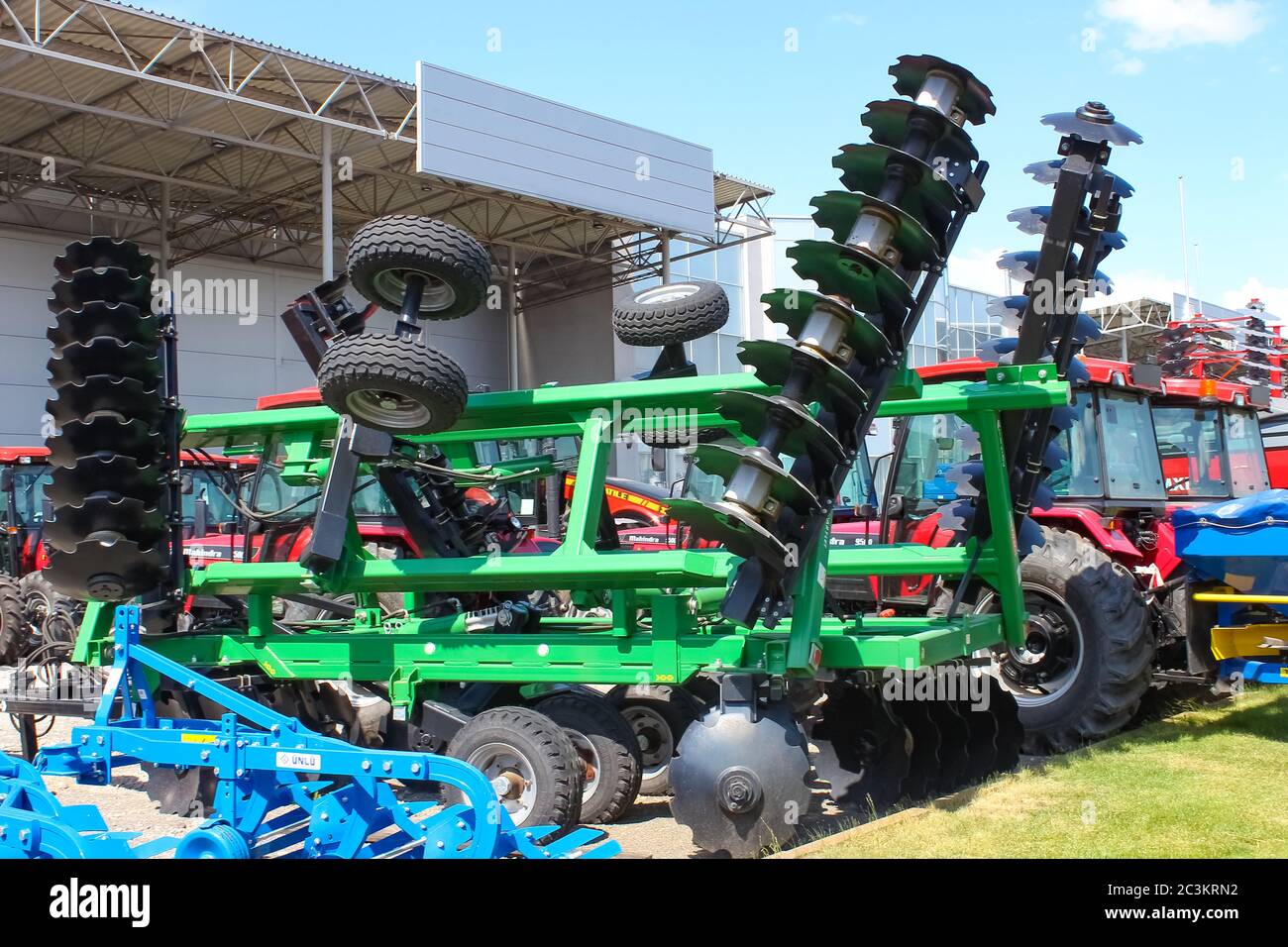 Large disc plough, towing for tractors to plow fields, against the sky