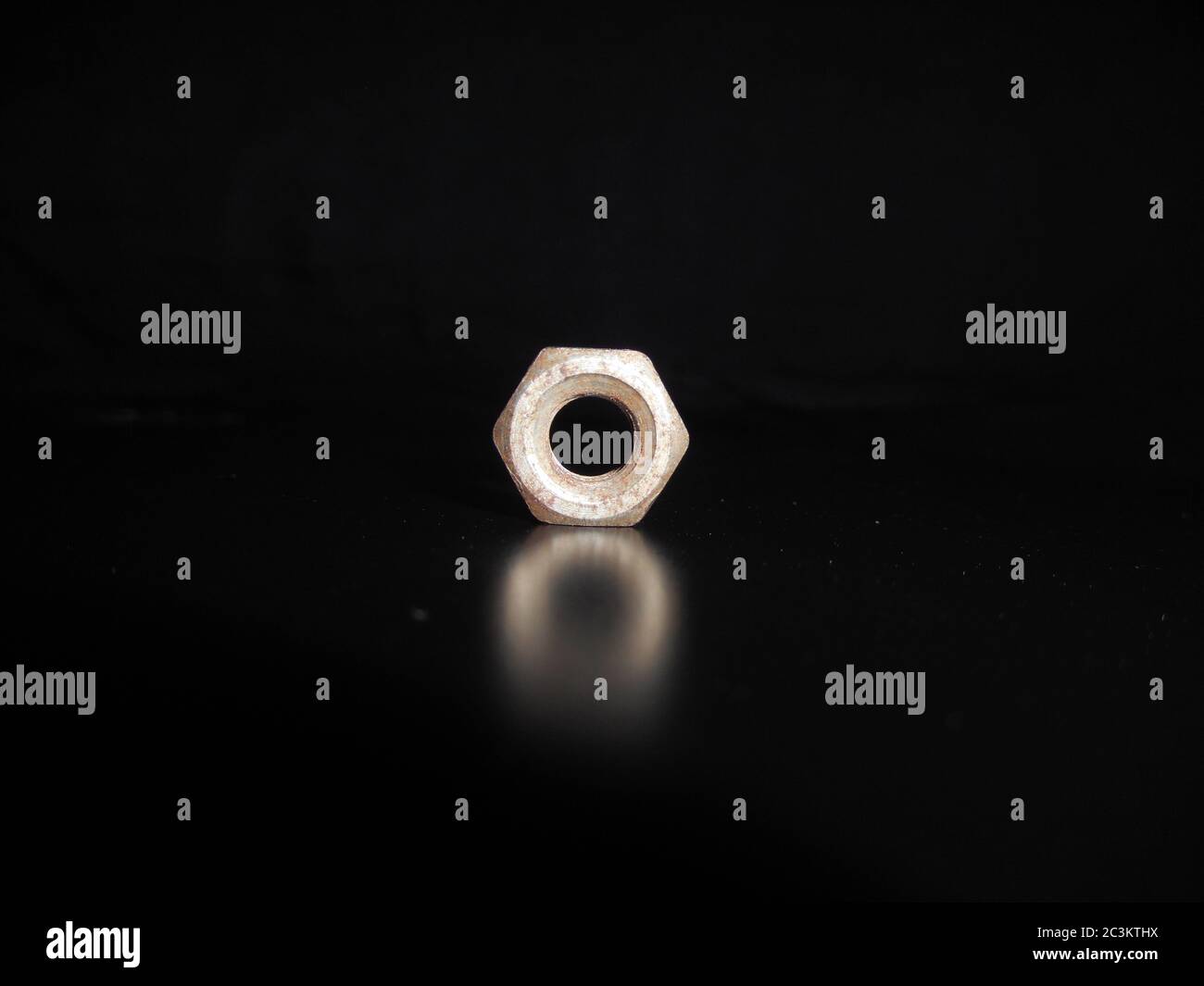 Metal nut or bolt isolated on black background. Stock Photo