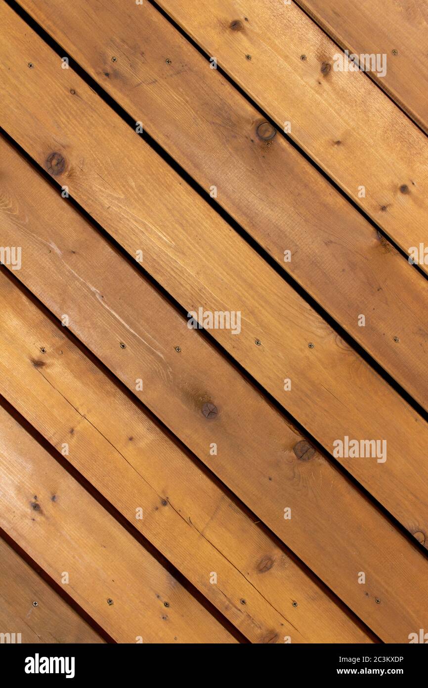 Close up diagonal texture background view of golden brown cedar wood