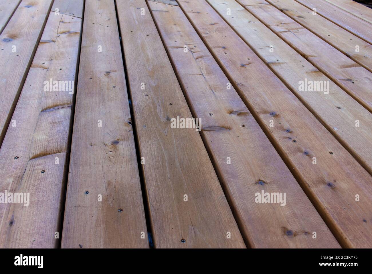 Close up texture background view of golden brown cedar wood deck