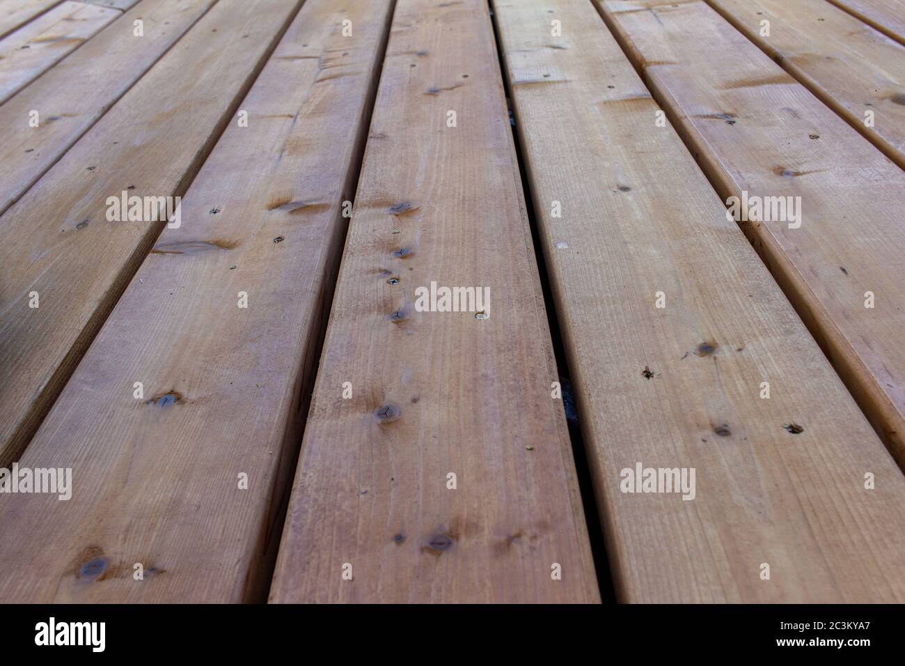 Close up texture background view of golden brown cedar wood deck floorboards Stock Photo