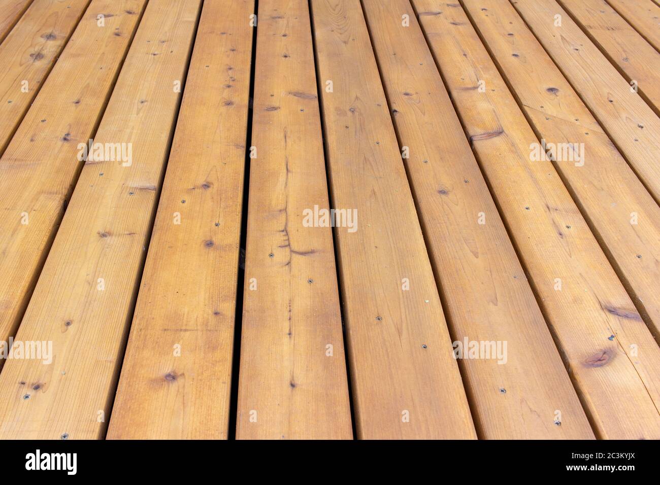 Close up texture background view of golden brown cedar wood deck floorboards Stock Photo