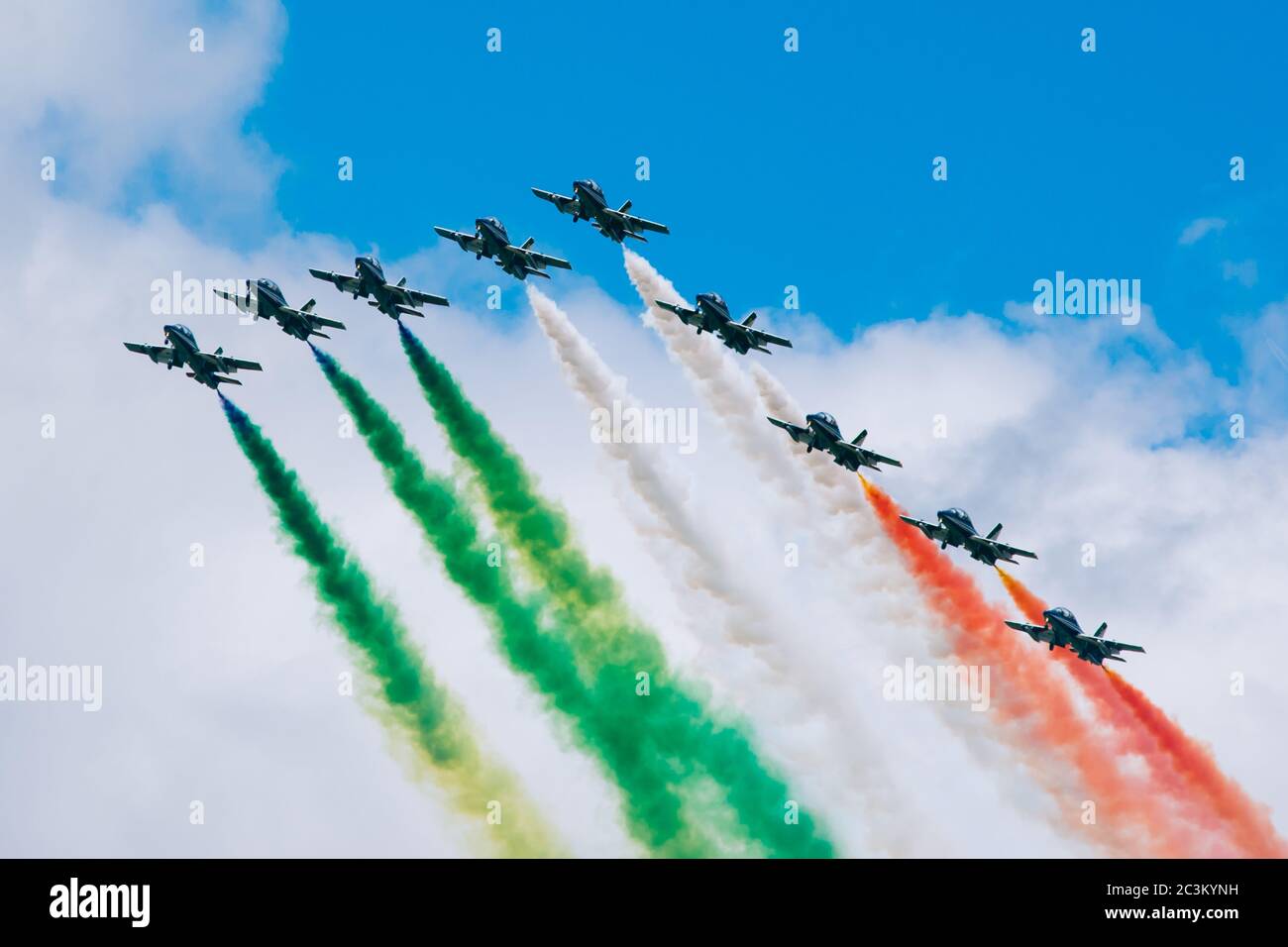 Shot of military planes flying and leaving smoke after them with the colors of the Italian flag Stock Photo