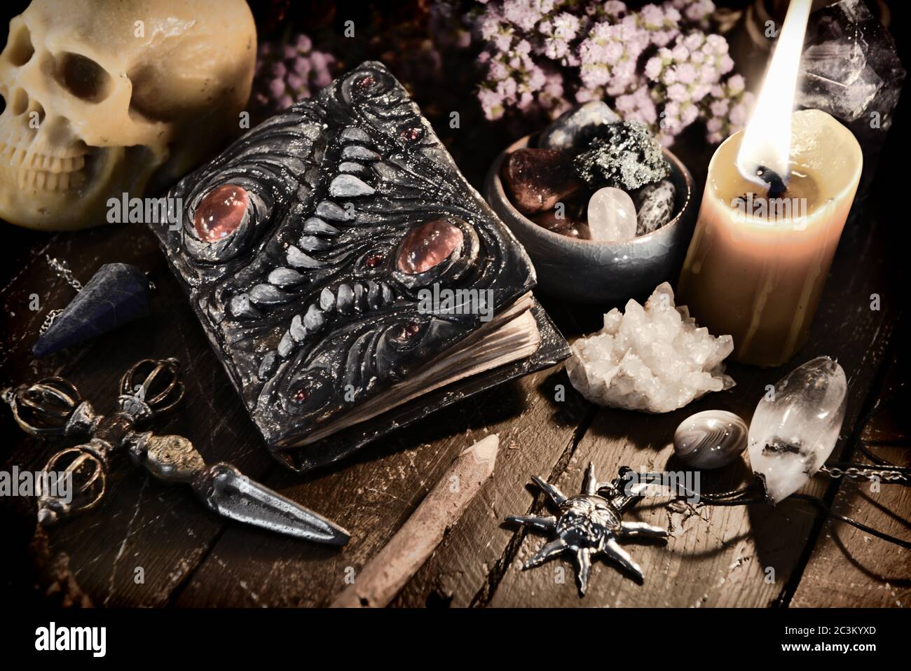 Scary evil book with skull and burning candle. Wicca, esoteric and
