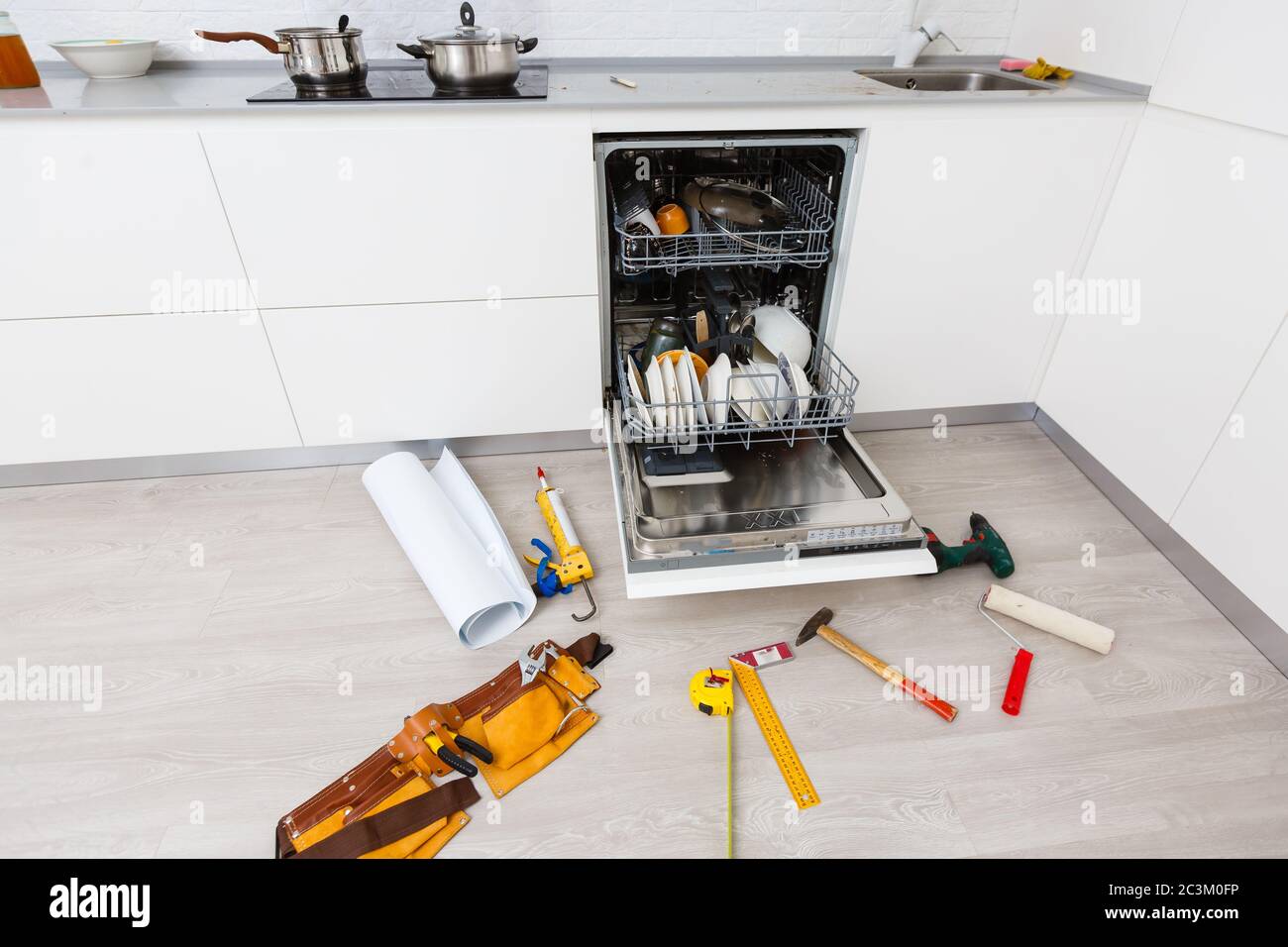 A broken dishwasher with lots of suds on the bottom but missing the