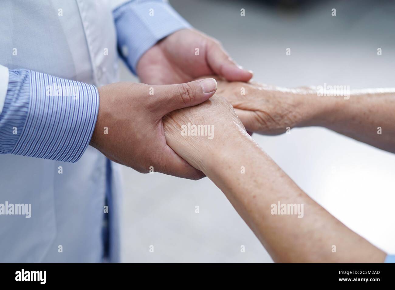 Holding Touching hands Asian senior or elderly old lady woman patient with love, care, helping, encourage and empathy at nursing hospital ward : healt Stock Photo