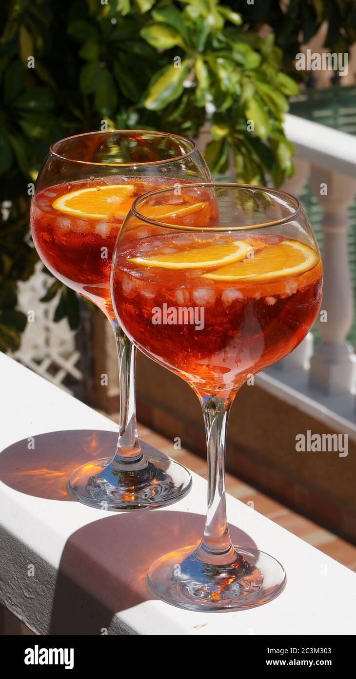 Aperol spritz in big glasses red summer cocktail, terrace party. High quality photo Stock Photo