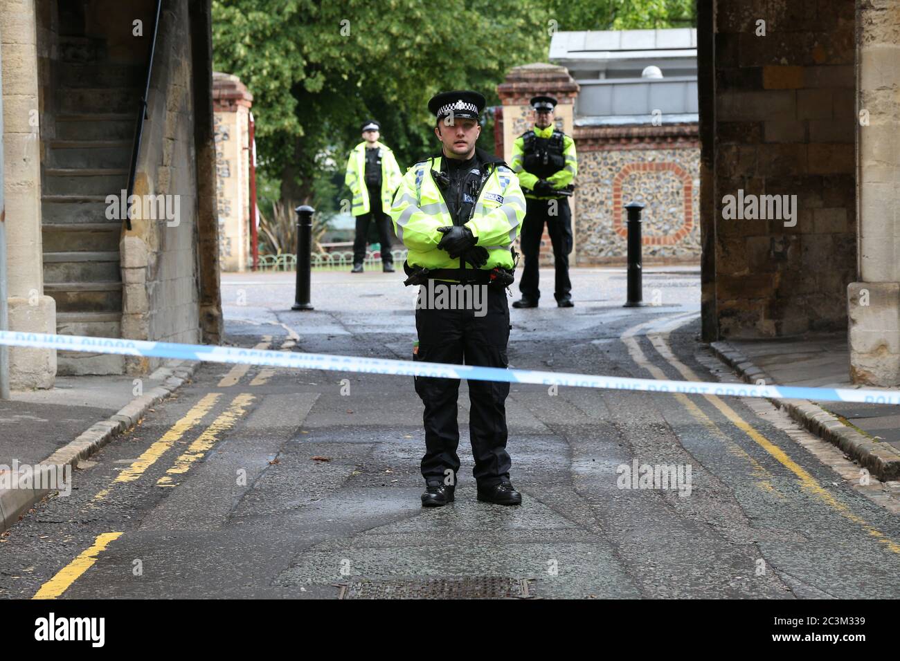Police at the Abbey gateway of Forbury Gardens in Reading town centre following a multiple stabbing attack in the gardens which took place at around 7pm on Saturday leaving three people dead and another three seriously injured. Stock Photo
