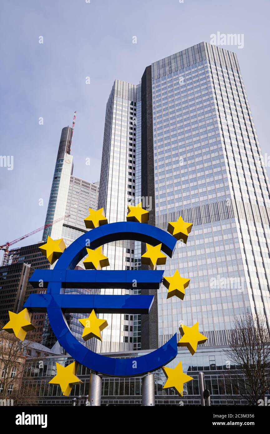 European Central Bank (ECB) building in the back of the Euro sign on a sunny day in Frankfurt am Main, Hessen, Germany Stock Photo