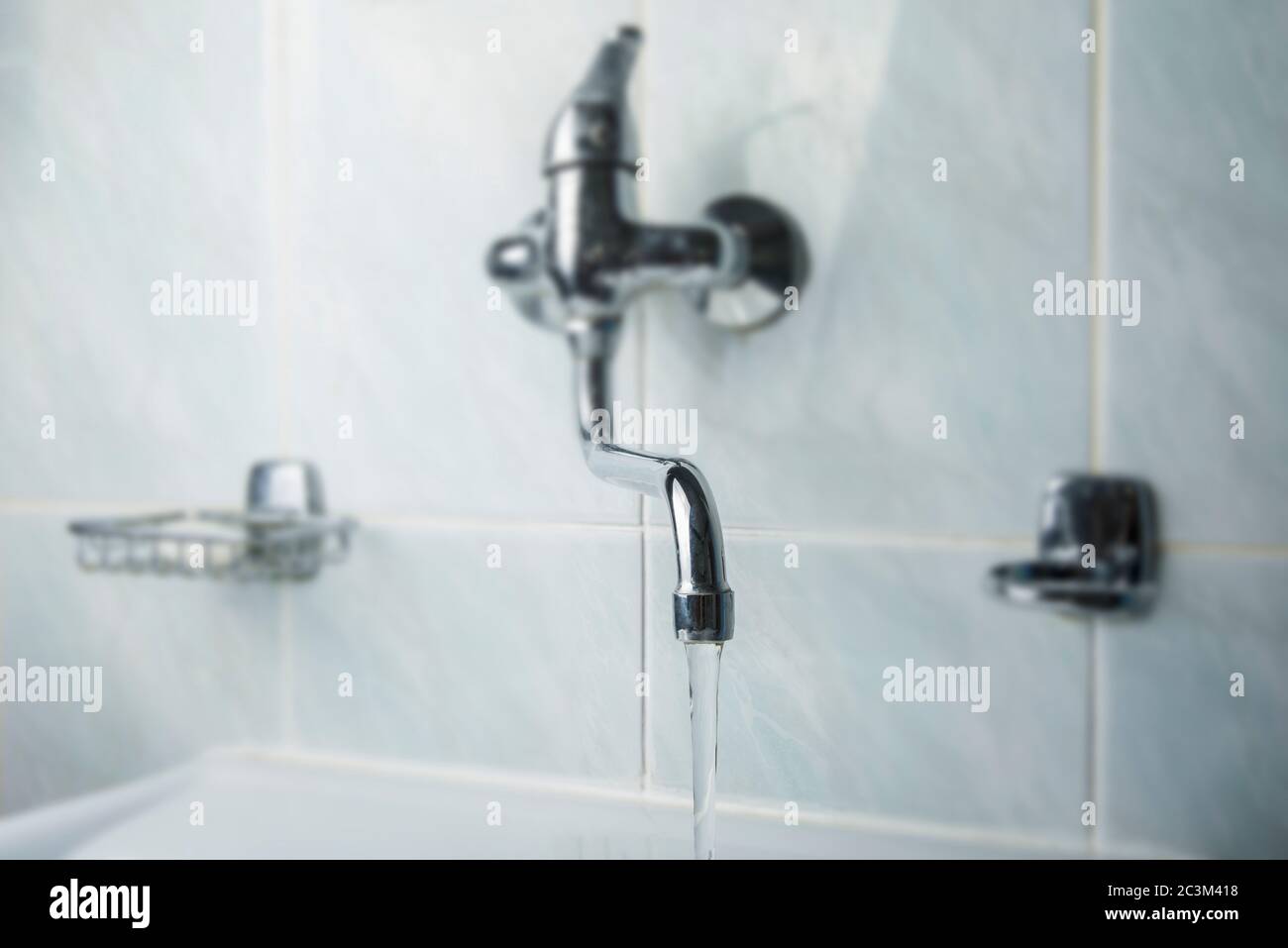 Running water faucet in the bathroom Stock Photo - Alamy