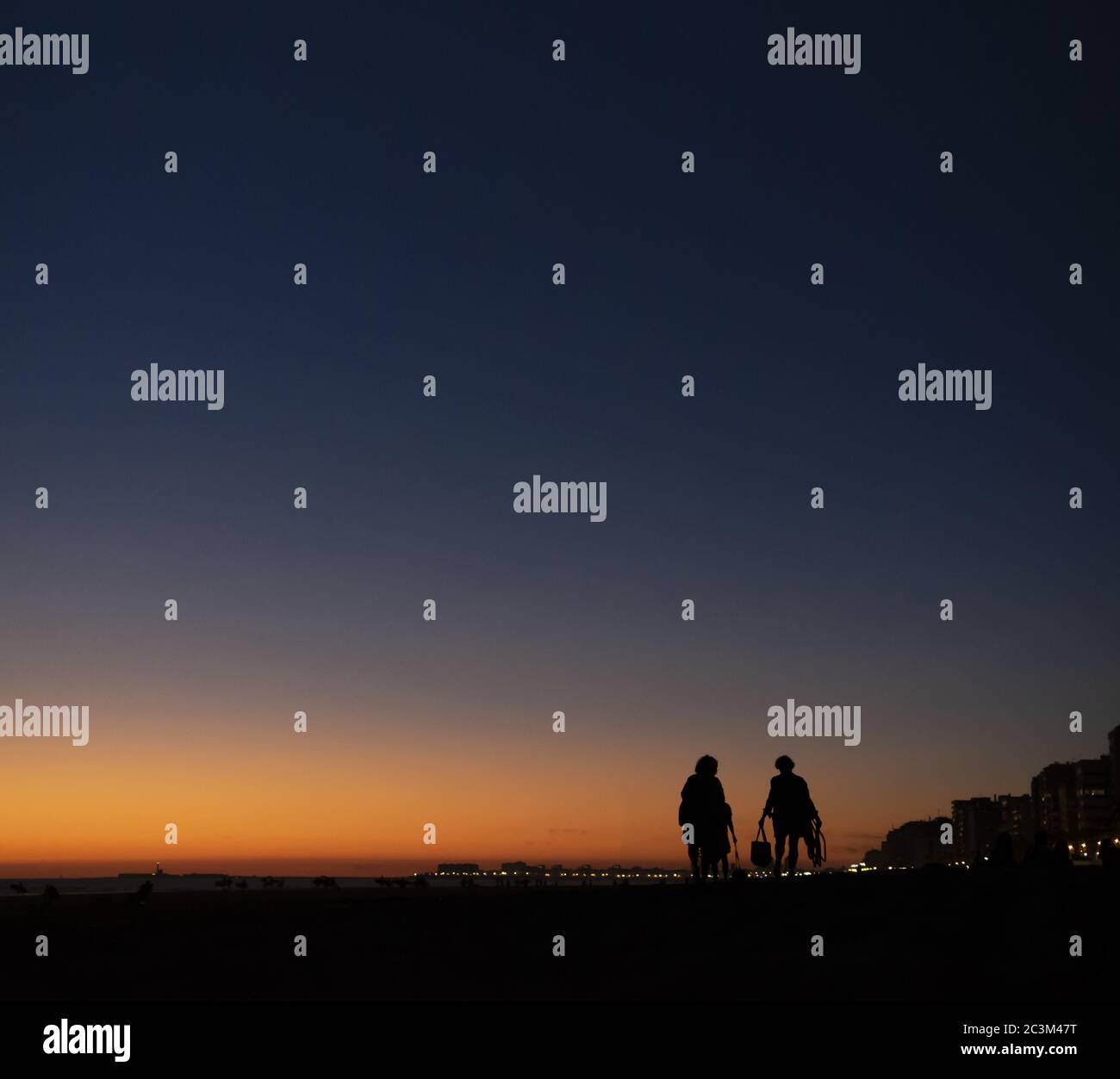 Silhouette scenery of tow people walking together at sunset Stock Photo ...