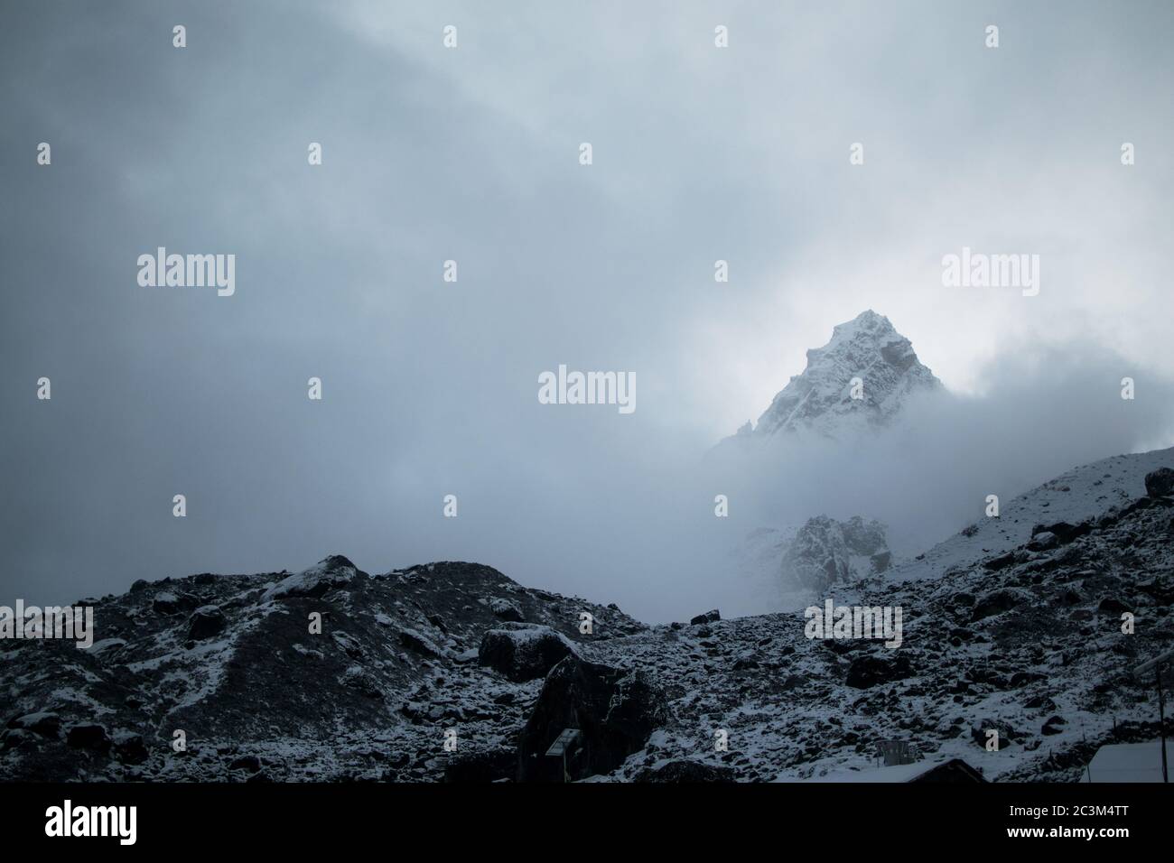 Breathtaking view of the snowy mountain summit in a foggy weather Stock ...