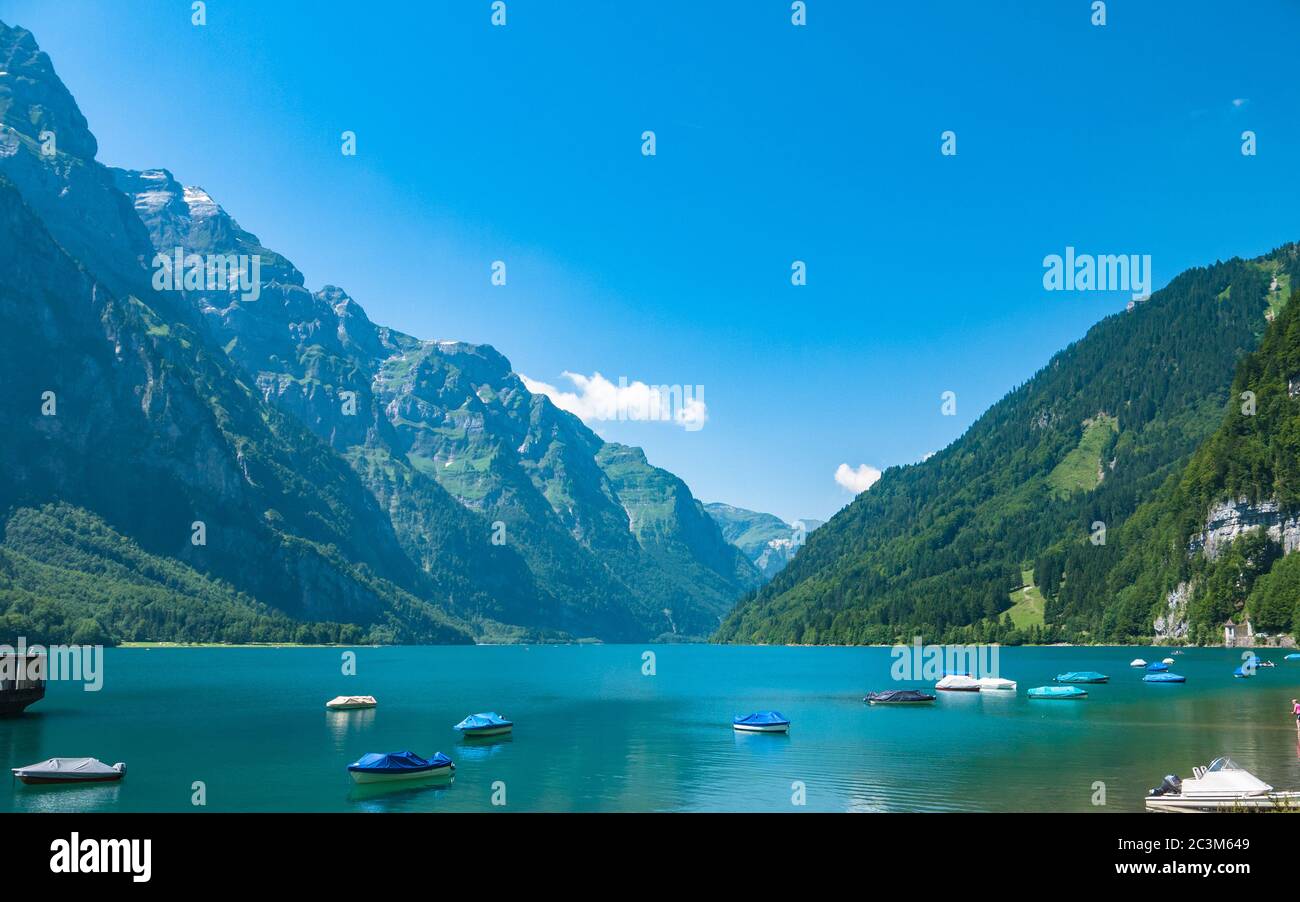 Stunning panorama view of Kloental lake (Kloenthalsee) and Bruennelistock (Brunnelistock) and Swiss Alps on a sunny summer day with blue sky cloud in Stock Photo