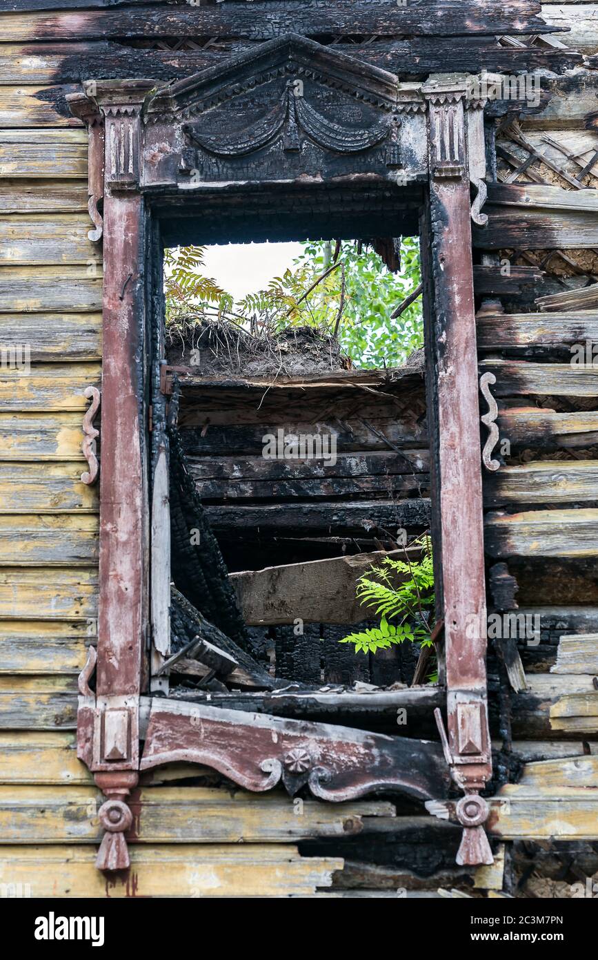 Part of the wall of an apartment building with charred window after a fire Stock Photo