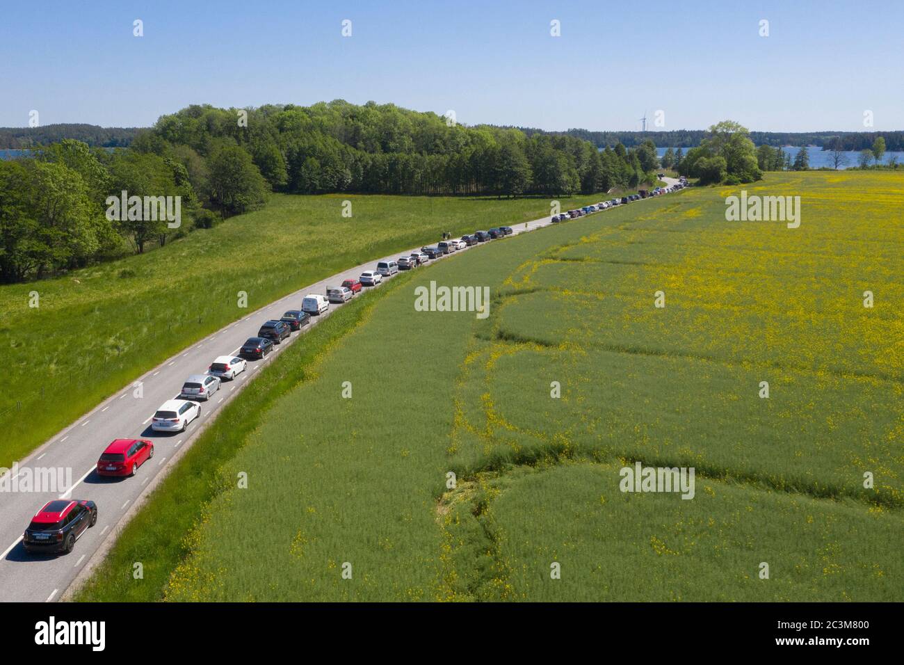 Cars queue for the ferry over to Ljusterö. Stock Photo