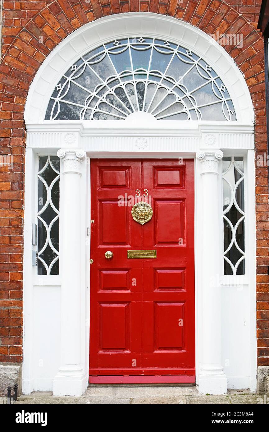 A red door in Dublin, Ireland. Arched door house front in
