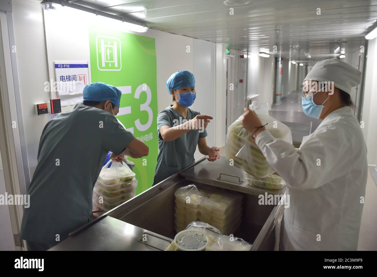 Beijing, China. 19th June, 2020. Nurses get meals for COVID-19 patients outside the isolation ward at Ditan Hospital in Beijing, capital of China, June 19, 2020. Beijing reported 227 COVID-19 cases on June 11-20. Credit: Peng Ziyang/Xinhua/Alamy Live News Stock Photo