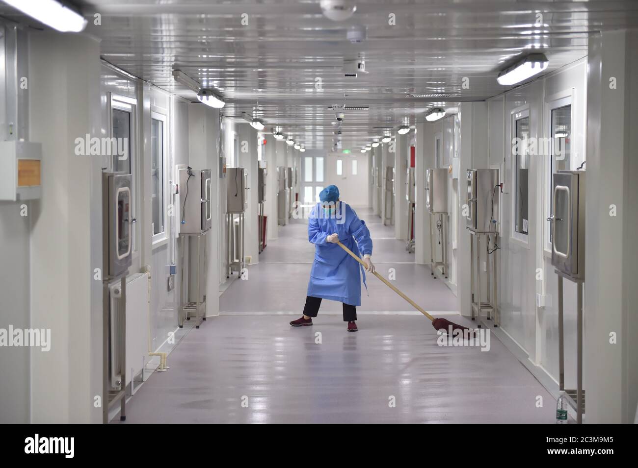 Beijing, China. 19th June, 2020. A staff member cleans the corridor outside the isolation wards at Ditan Hospital in Beijing, capital of China, June 19, 2020. Beijing reported 227 COVID-19 cases on June 11-20. Credit: Peng Ziyang/Xinhua/Alamy Live News Stock Photo