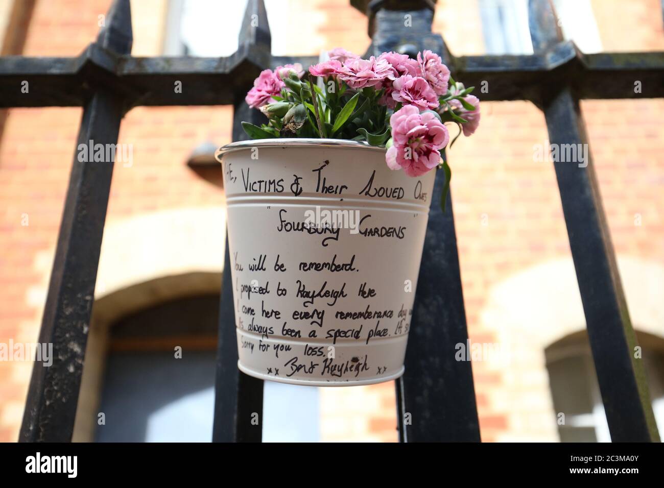 Flowers and a message left at the Abbey gateway of Forbury Gardens in Reading town centre following a multiple stabbing attack in the gardens which took place at around 7pm on Saturday leaving three people dead and another three seriously injured. Stock Photo