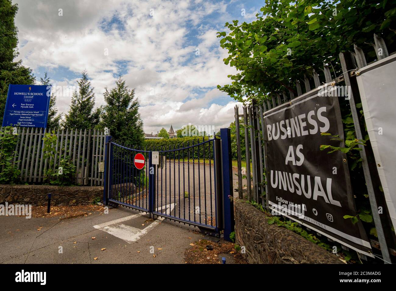 A school gate of Howell’s School in Cardiff with a sign saying ‘business as unusual’, June 2020. Stock Photo