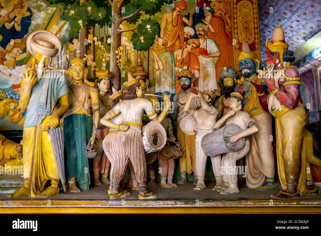 A colourful display of human figures including musicians and drummers in the main Image House at Wewurukannala Vihara at Dickwella in Sri Lanka. Stock Photo