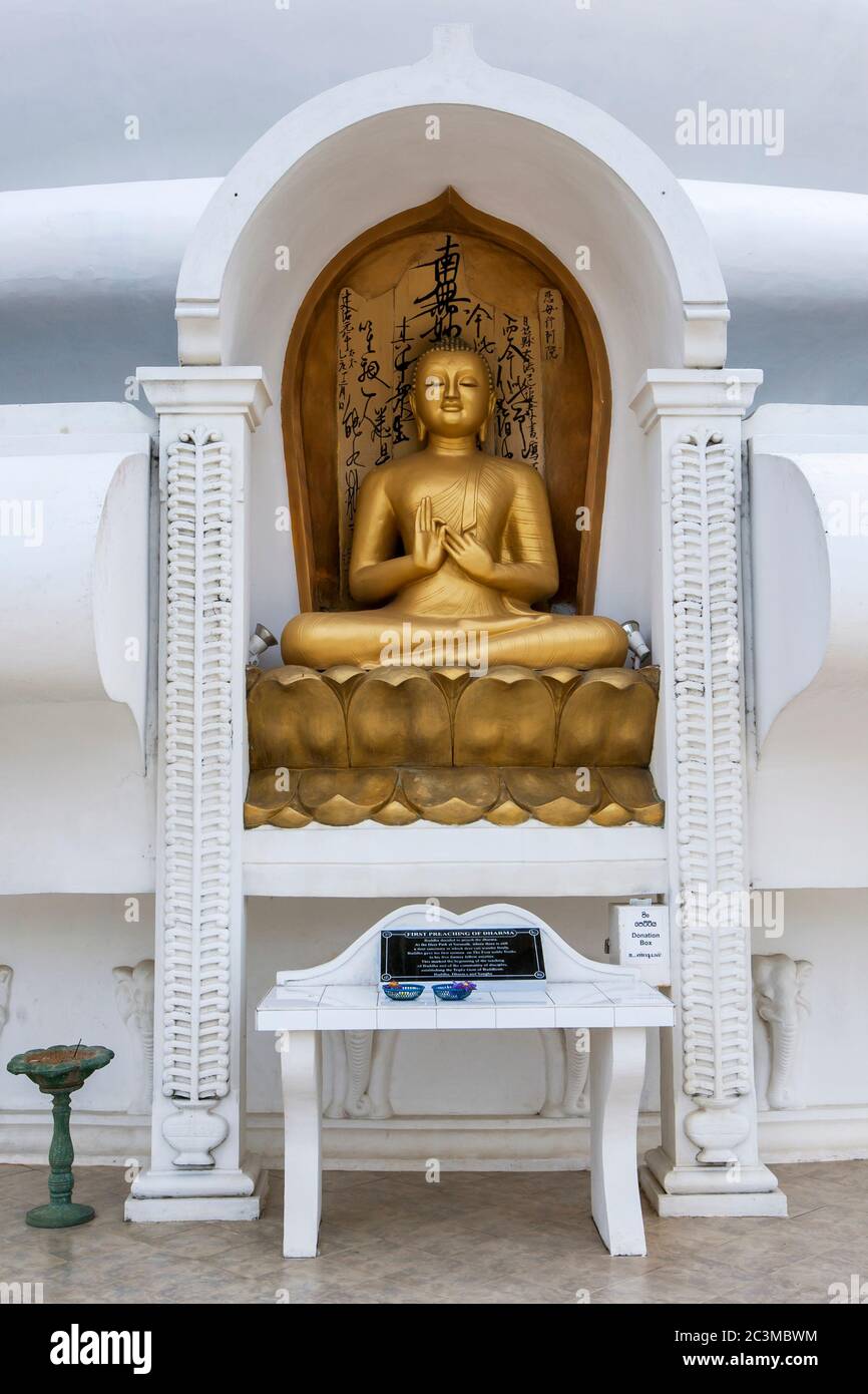A statue depicting the first preaching of Dhama by Buddha at the Peace Pagoda and Japanese Temple stupa at Jungle Beach at Unawatuna in Sri Lanka. Stock Photo