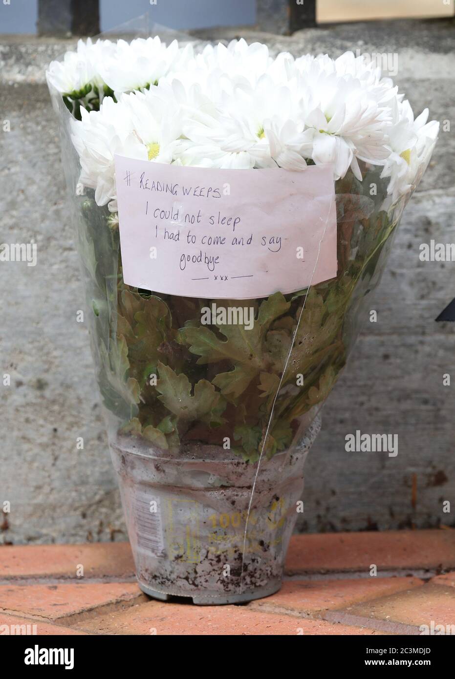 A message left on some flowers at the Abbey gateway of Forbury Gardens in Reading town centre following a multiple stabbing attack in the gardens which took place at around 7pm on Saturday leaving three people dead and another three seriously injured. Stock Photo