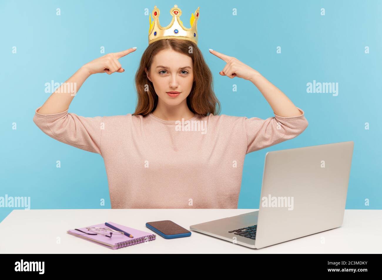 Look, I am boss here! Proud ambitious egoistic narcissistic businesswoman pointing at crown on head and looking with arrogance, over-inflated ego. ind Stock Photo