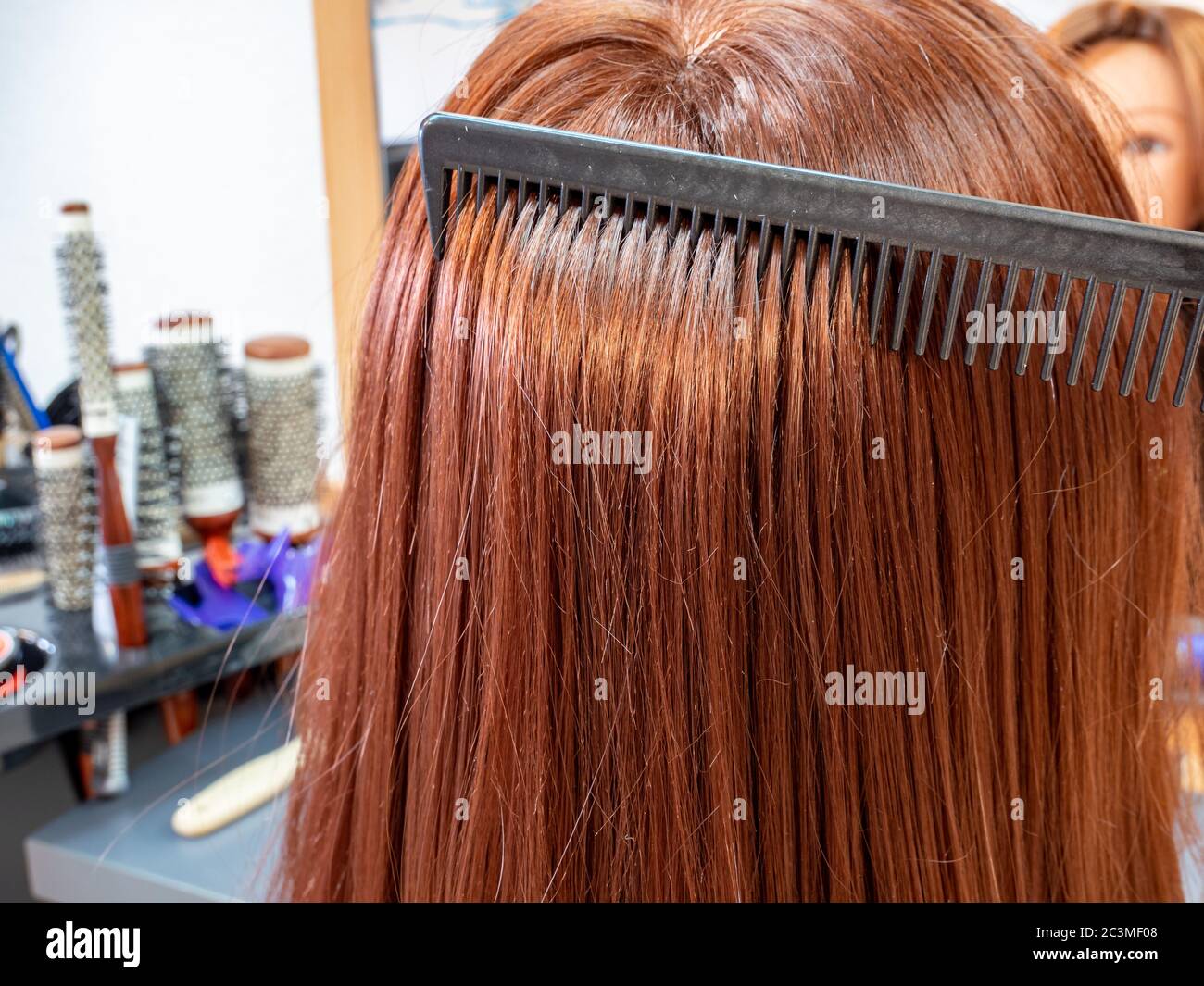 Woman with red hair at the hairdresser Stock Photo