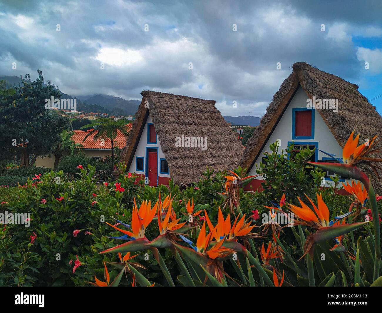 Beautiful scenery of two cabins  with cloudy sky in background in Casas Típicas in Santana Portugal Stock Photo
